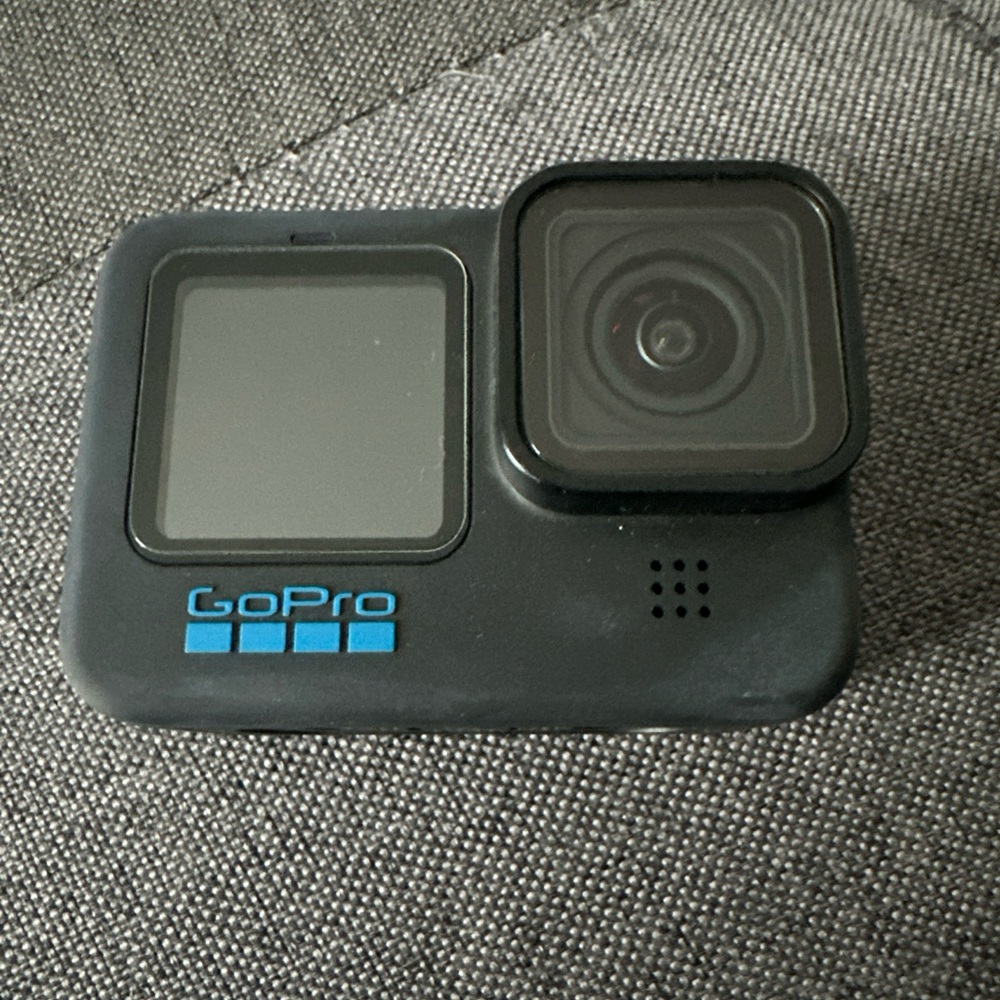 Go Pro 11 black camera with 12 piece accessories.